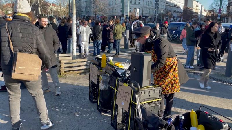 Sunny winter Sunday morning in Mauerpark, a crowd cheerfuly dances to DJ Omlet's performance while he cooks and mixes at the same time.