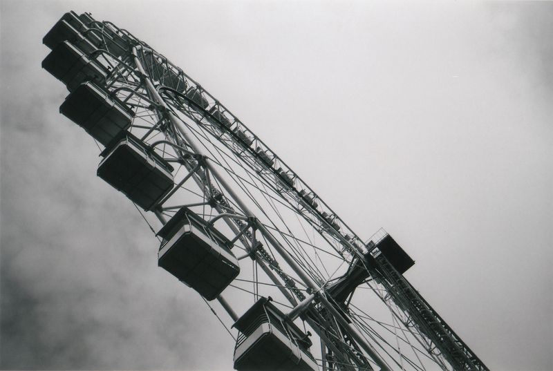A moody black-and-white ferris wheel close-up shot from the hip with Lomo LC-A