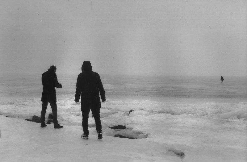 Snow, wind and a few people walking on the ice